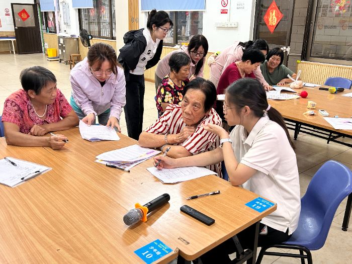 圖為團(tuán)隊(duì)成員在向老人收集問(wèn)卷 李香濘攝